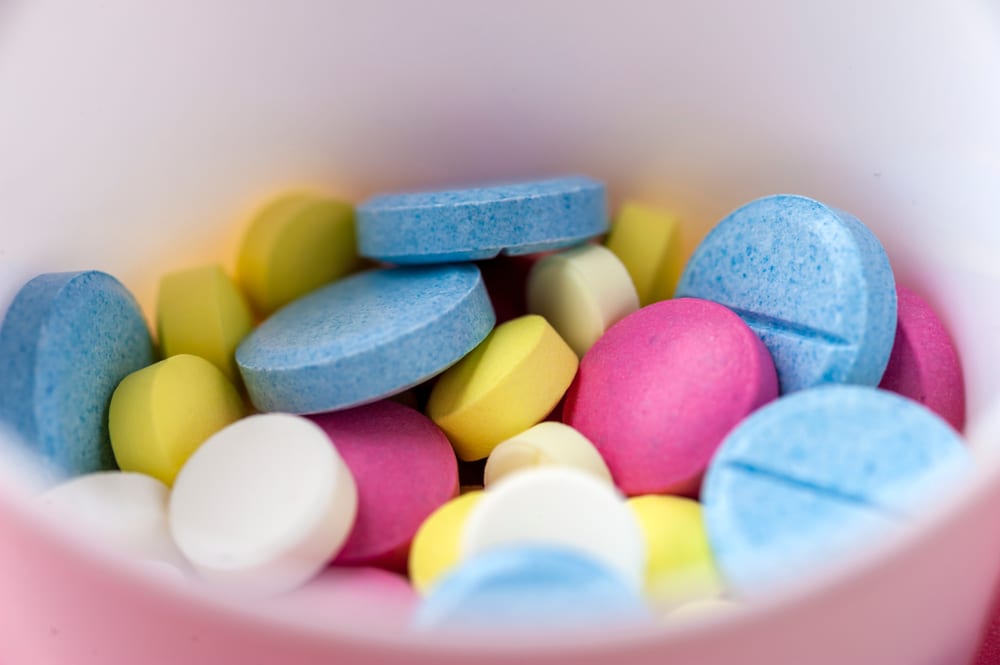 Colorful supplement tablets representing custom flavor and color matching