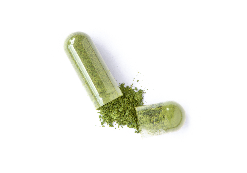 Powder-filled capsule opened to show its contents