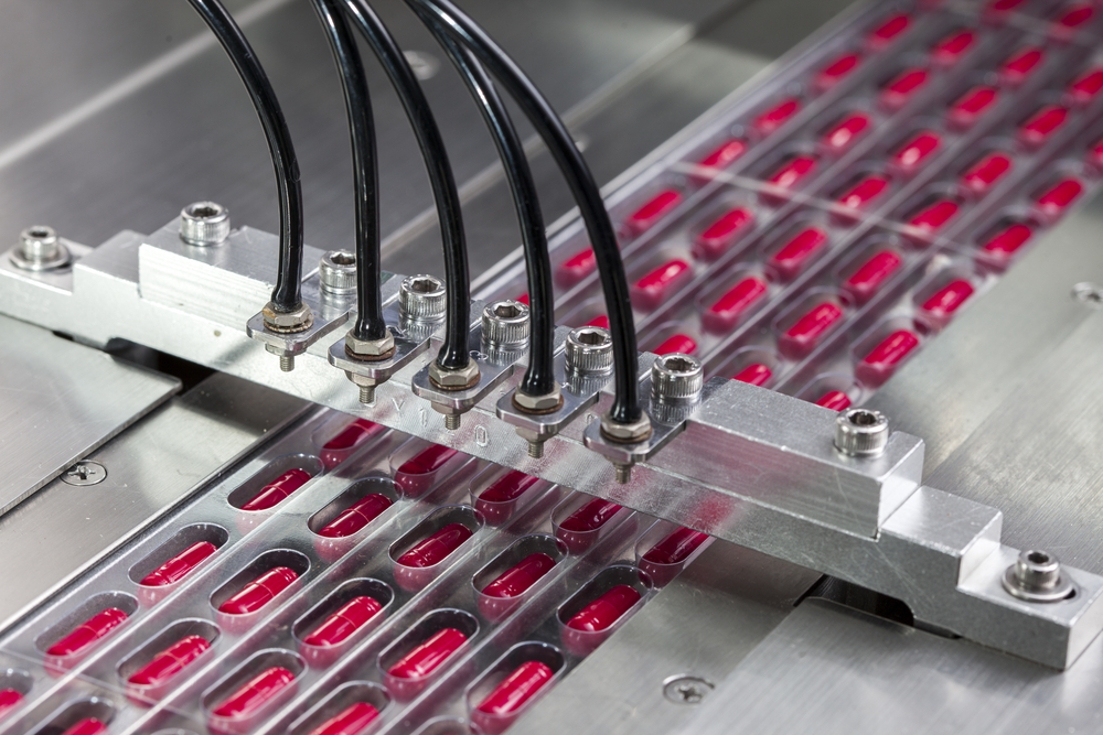 Capsules held in machine trays during the wet granulation drying phase