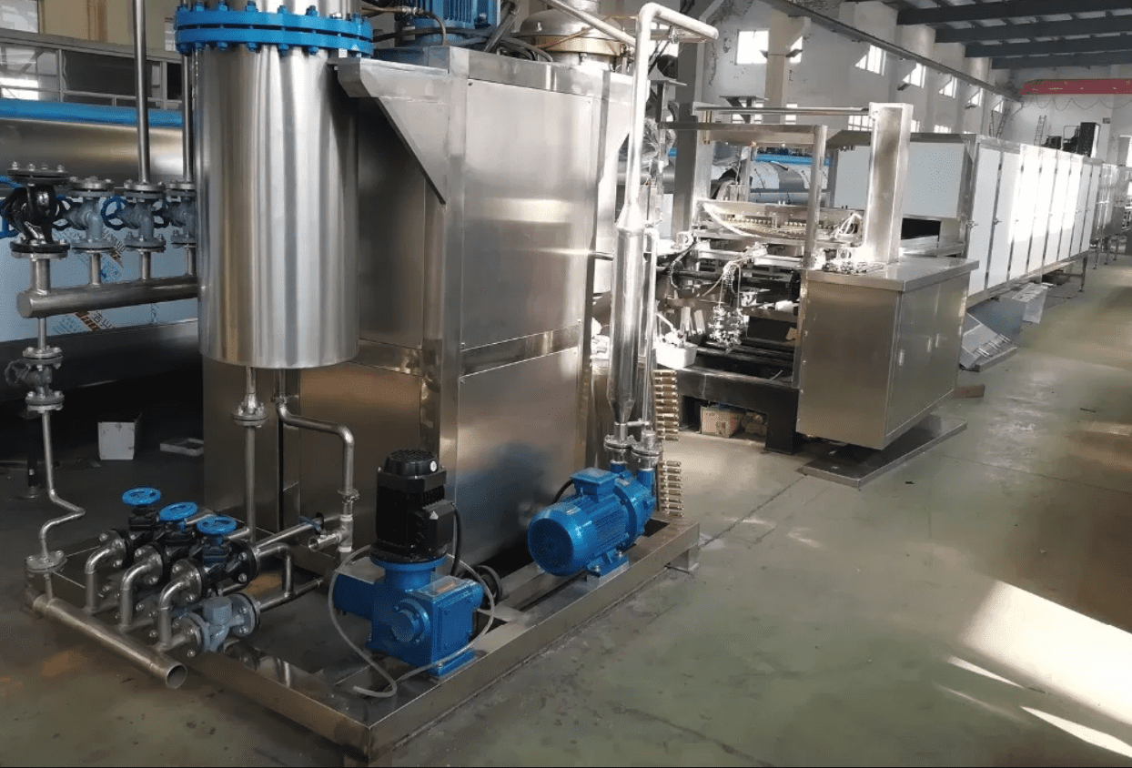 Stainless steel mixing and cooking equipment used to blend and cook gummy slurry