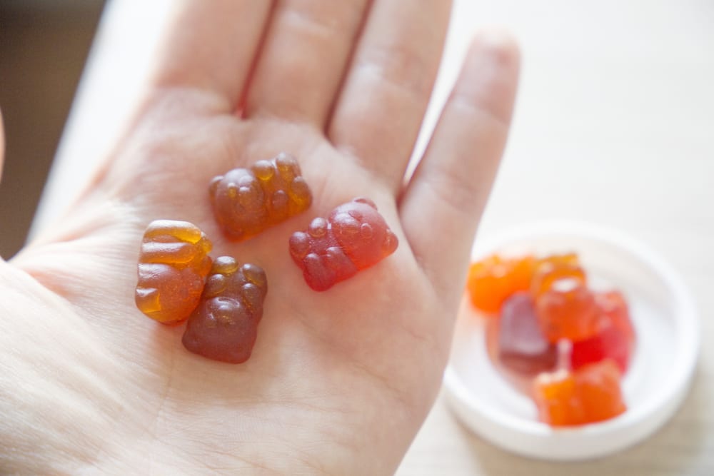 Assorted gummy bear vitamins held in an open hand