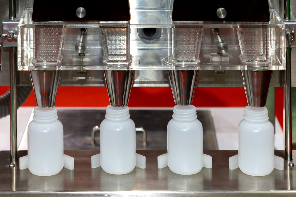 Bottle filling machine dispensing finished softgels into supplement bottles